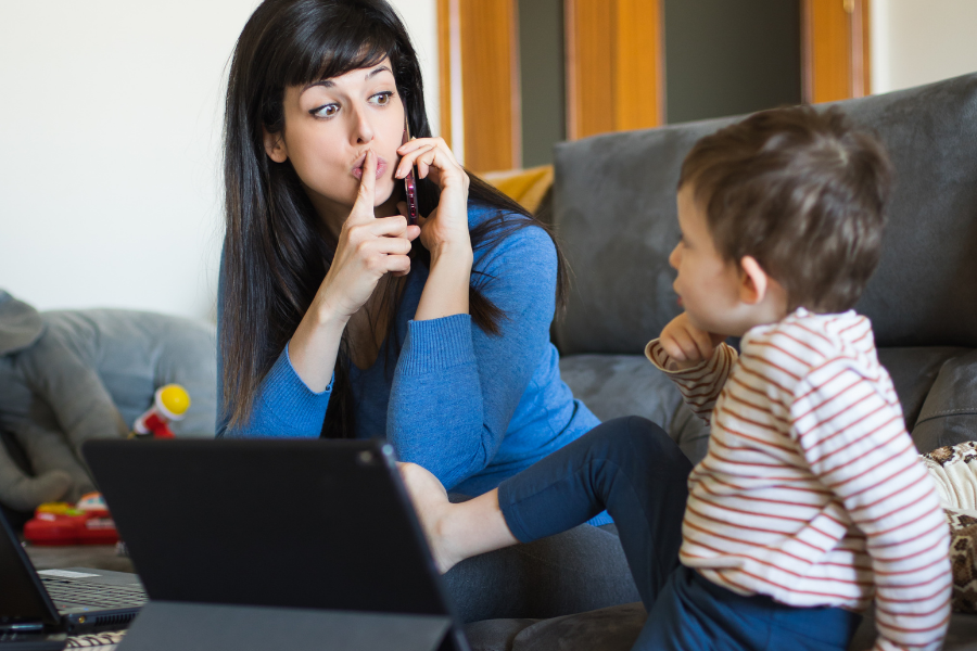 telecommuting mother disturbed by her child while on the phone