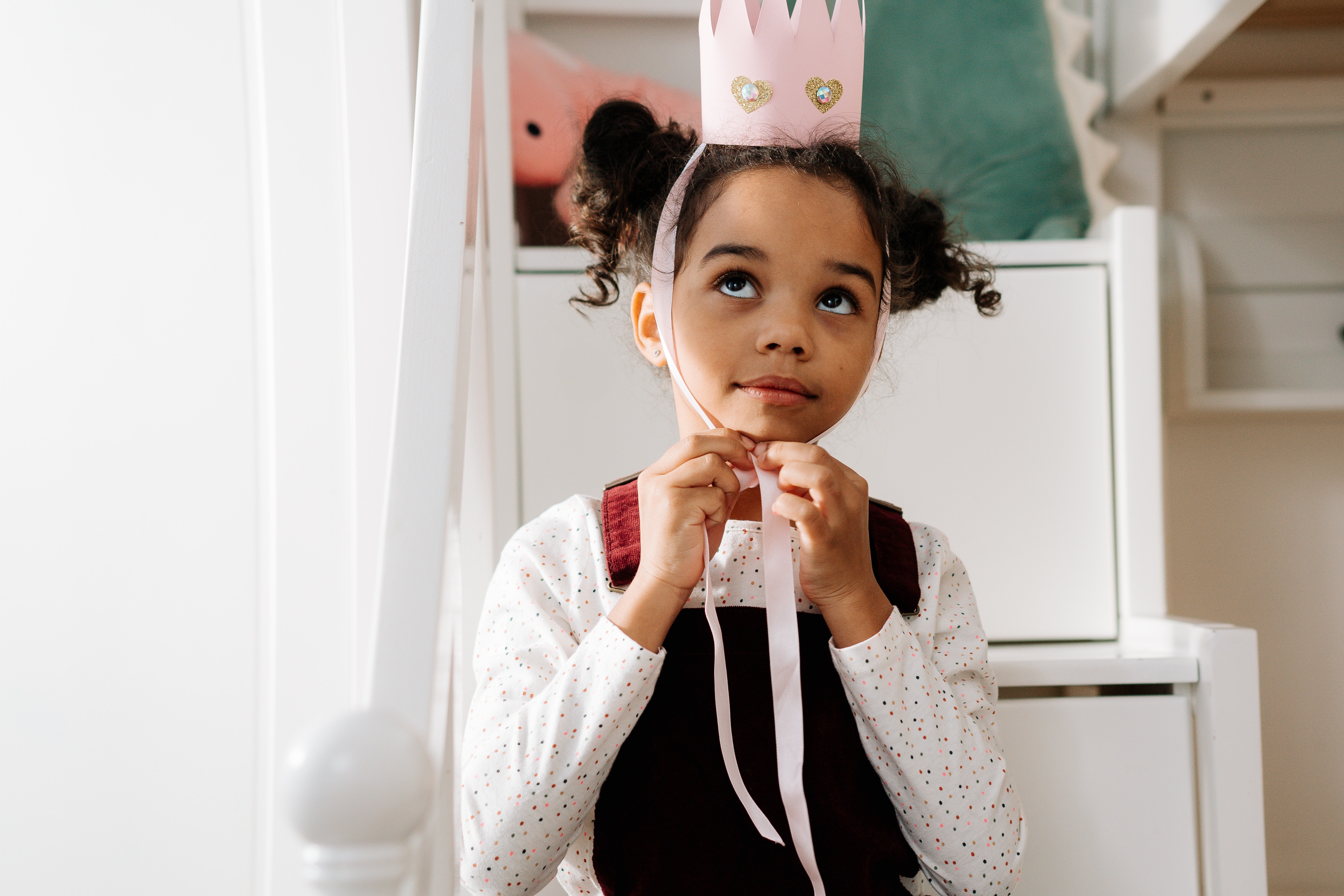 Une enfant avec une couronne, simulant les "enfants rois" des écoles Montessori